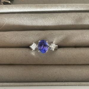 Purple oval tanzanite with Diamond baguette ring. 14k white gold.